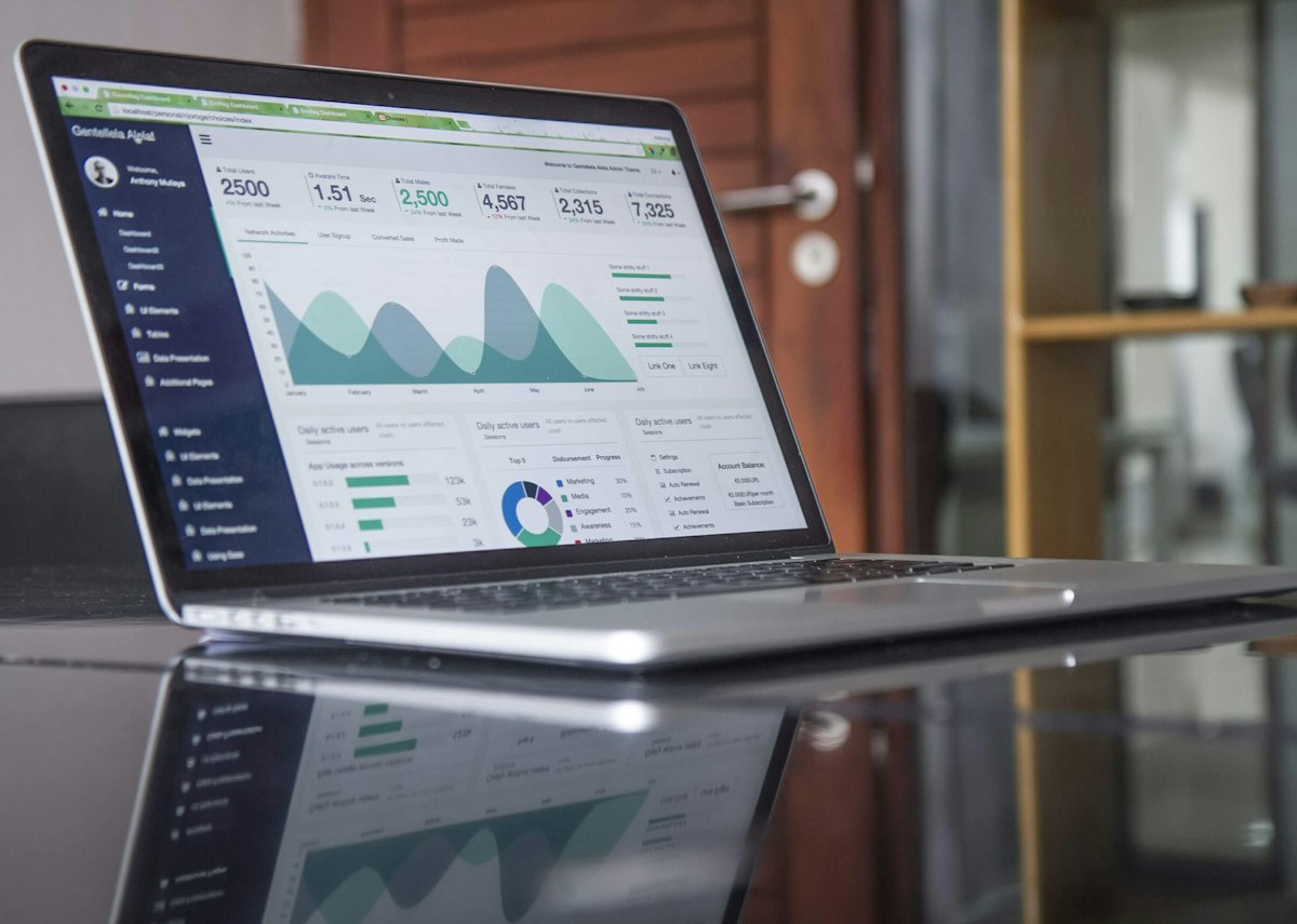 Laptop showing a presentation with charts and dashboards